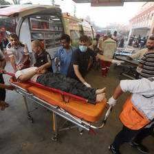 Paramedics bring an injured man to hospital