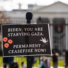A sign in front of the White House accuses Joe Biden of starving Gaza