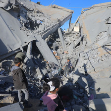 Children among the remains of a school that Israel has destroyed in Gaza 