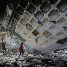 children walk in rubble