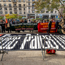 People gather around a banner reading Free Palestine and other banners in New York's Columbia University 