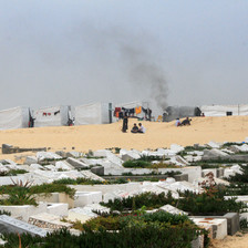 Makeshift tents on sand beside a cemetery in the southern Gaza city of Rafah 