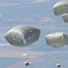 Aerial image of parachutes descending onto land 