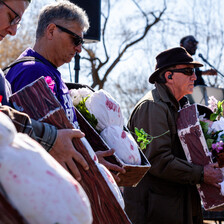 People hold imitation children's coffins