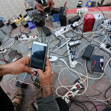 A bunch of phones being charged on a mobile battery