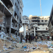 People stand in what remains of the area around Gaza's largest hospital 
