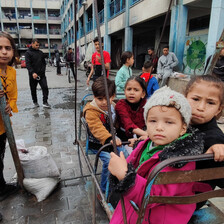 Children play on swings at a Gaza school that has been turned into a shelter. 