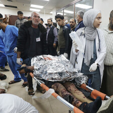 An injured patient is brought into a hospital on a stretcher 