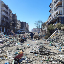 A man walks in the rubble of an area that has been attacked by Israeli forces 