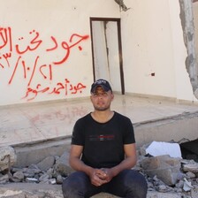 A man sits beside the remains of a home in central Gaza 