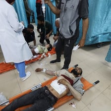 People are treated on the floor of a hospital