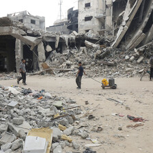 Children with water canisters among a scene of destruction in southern Gaza 