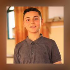 Portrait of a boy wearing a gray short sleeved shirt 