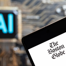 A table with the masthead of The Boston Globe
