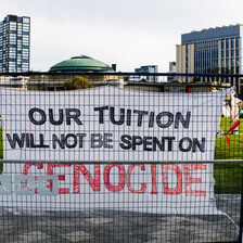 A sing reads: Our tuition will be spent on genocide