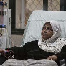 A woman receives treatment in a hospital bed