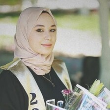 A young woman smiles at the camera