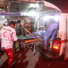 Paramedics put an injured person in an ambulance