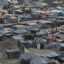 Dozens of tents fill a sandy space