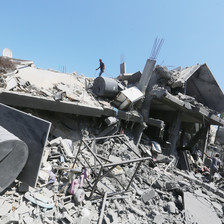 A man amid a large amount of rubble in central Gaza 