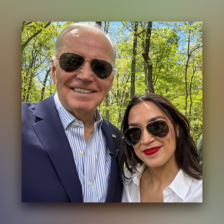 Man and woman pose together in sunglasses against a backdrop of trees