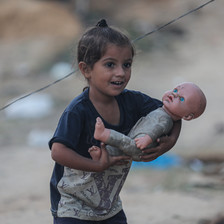 A child holds a doll 