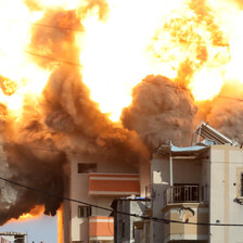 A fireball rises over a building