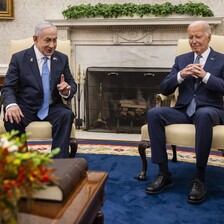 Netanyahu and Biden sit next to each other in chairs