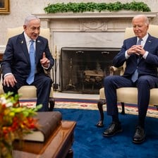 Netanyahu and Biden sit next to each other in chairs