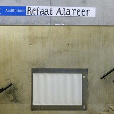 A sign reading Auditorium Refaat Alareer 