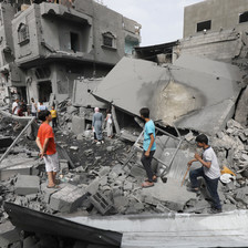 People inspect damage to homes in Gaza