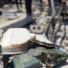 Damaged books lie in rubble