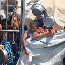 Children with empty pots await food aid