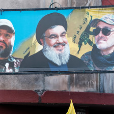 A billboard shows Nasrallah with two comrades 