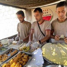 Three men make falafel