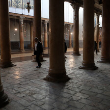 One person walks down the middle of an empty church