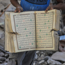 A man holds up a Quran