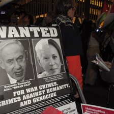 a poster decrying the war crimes of Netanyahu and Biden Harris