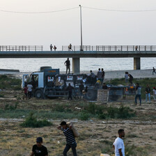 people carry goods away from a truck