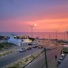 A building beside a road in a sunset 