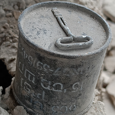 A small bomb with what appears to be a lid and a key on top of it 