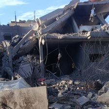 A home now collapsed on itself, the second floor roof falling.