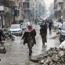 People walk amid rubble on a street in Gaza City