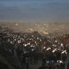 A crowd surges around aid trucks in northern Gaza