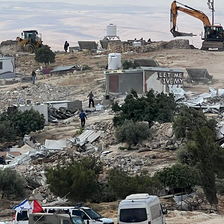 Bulldozers tear through a small village