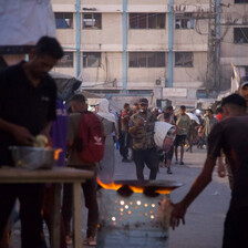 A street vendor prepares falafel at dusk