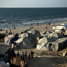 Makeshift tents laid out on the shore