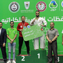 People pose with their medals on a podium