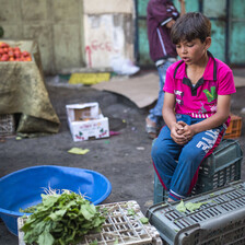 Boy sits on a crate 