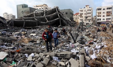 Two boys standing in the middle of rubble